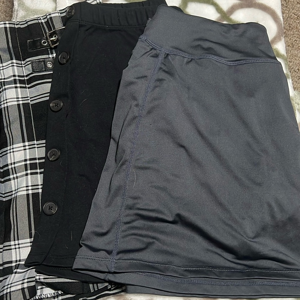 Three Skirts sizes medium(athletic and plaid skirt) and 1 small(black skirt).
